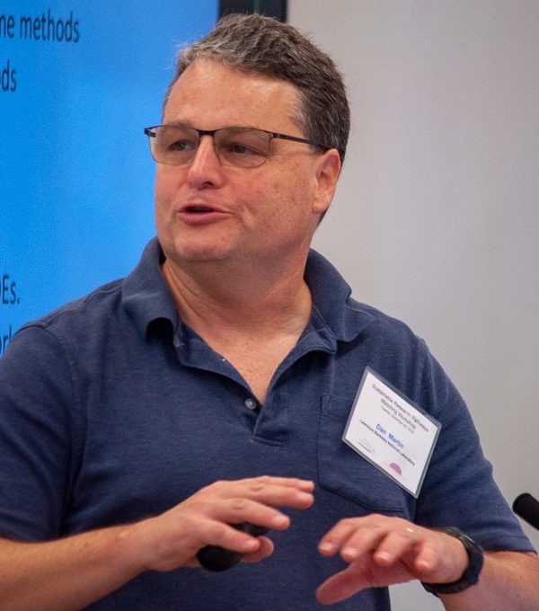 Dan Martin giving a presentation in front of a screen