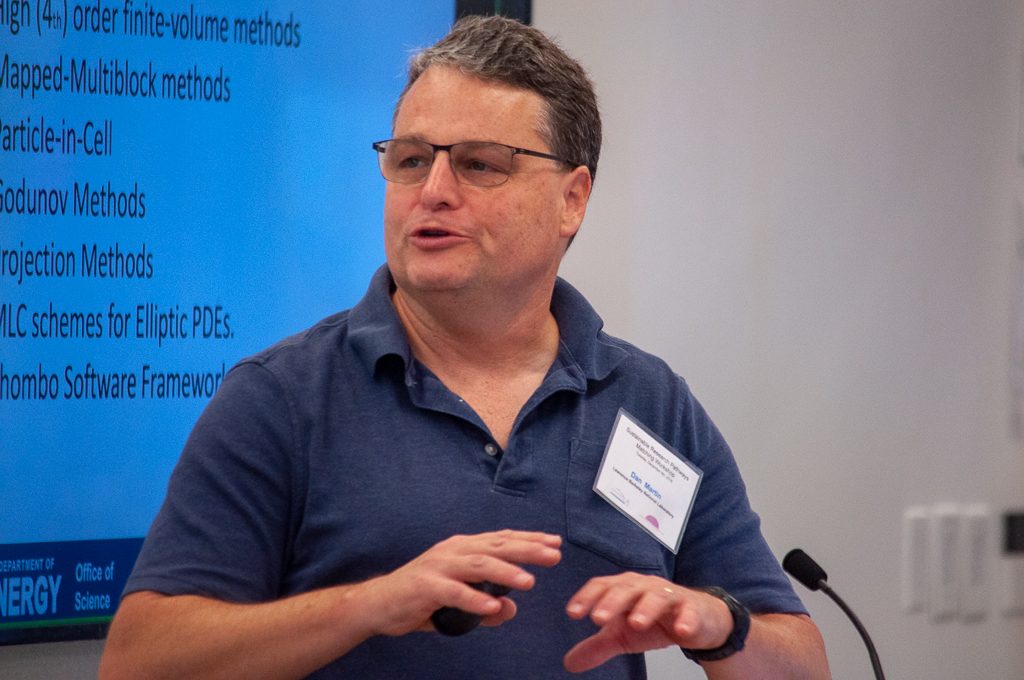 Dan Martin giving a presentation in front of a screen